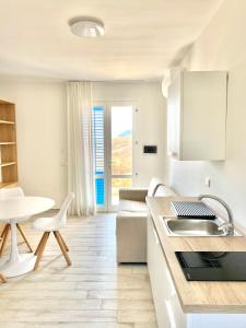 eine Küche und ein Wohnzimmer mit einem Sofa und einem Tisch in der Unterkunft Bilocale Bellavista in Marettimo