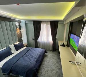 a bedroom with a large bed and a television at Forever 21 Hotel in Istanbul