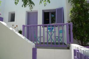 a purple railing on a balcony with a door at Vourkari Studio in Gialiskari