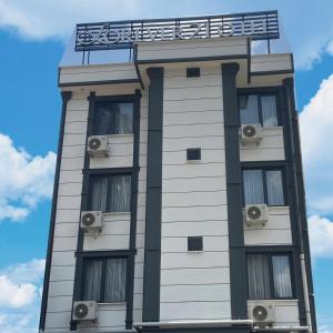 a tall white building with a sign on top of it at Forever 21 Hotel in Istanbul