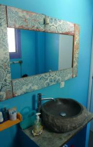 a bathroom with a stone sink and a mirror at Vourkari Studio in Gialiskari