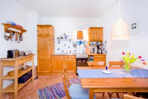 a kitchen with a table and a dining room at Ferienhaus Namatiri in Putbus