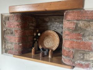 a wicker basket sitting on a shelf in a brick fireplace at Gilling Gap in York