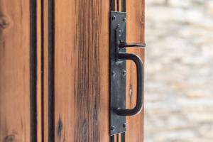 a black door handle on a wooden door at Gilling Gap in York