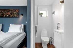 a bedroom with a bed and a bathroom with a sink at Selfoss Modern Cabins in Selfoss