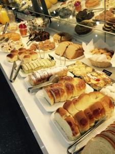 a display case filled with lots of different types of pastries at JP Palace Hotel in Franca