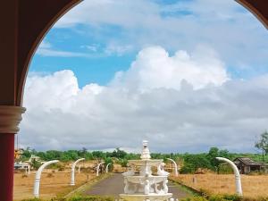 a view of a road through an archway at Shiv Sagar Palace,Ganpatipule in Ganpatipule