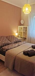 a bedroom with a large bed and a chandelier at Mediterrania Apartment in Keszthely