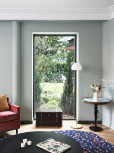 a living room with a large sliding glass door at Hôtel Botaniste in Paris