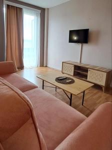 a living room with a couch and a table at Hotel Park in Negotino