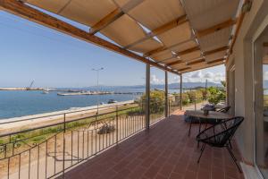 a balcony with a view of the water at Phaos in Kyparissia