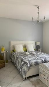 a bedroom with a large bed with a comforter at Chambres Quiétude in Chavanoz