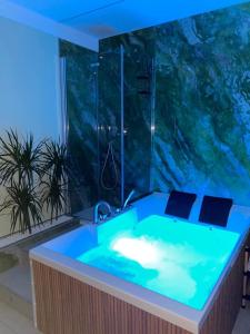 a bathroom with a tub with a large aquarium at Alma Salina Suite in Margherita di Savoia