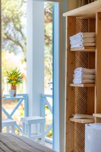 a room with a shelf with towels and a window at La Salvia Hotel Kas in Kaş
