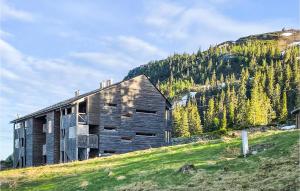 an old building on a hill with a mountain at Awesome Apartment In Fvang With Wifi And 3 Bedrooms in Favang