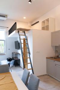 um quarto com uma escada na parede e uma cozinha em Apartment Trg em Brežice