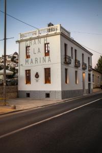 a white building on the side of a street at Gran H La Marina in Altea