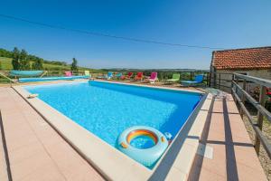 a swimming pool with a pool noodle in the middle at Lot & Garonne - Magnifique gîte de groupe avec piscine et vue panoramique en pleine campagne Proche Agen in Castelmoron-sur-Lot