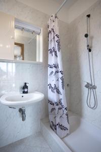 a bathroom with a sink and a shower curtain at Apartments Lonzor in Selce