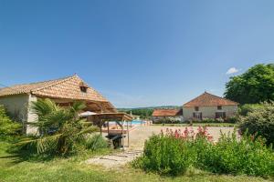 a resort with a swimming pool and two buildings at Le Domaine de Stellac in Castelmoron-sur-Lot