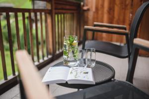 a table with a book and glasses on a porch at Guesthouse St Nikolaus in Ultimo