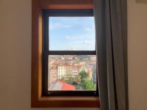 a window with a view of a city at Ferreira Borges Nomadic Ap A in Porto