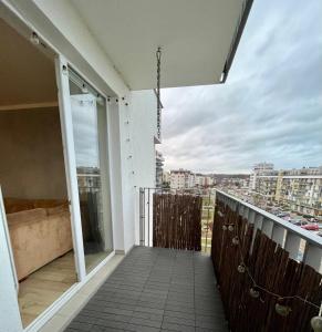 a balcony with a view of a city at Przytulna Apartment close to the airport and PKM in Gdańsk