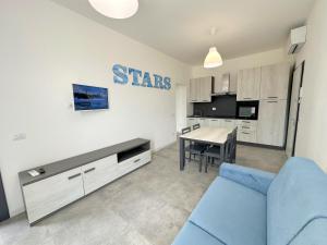 a living room with a blue couch and a table at LUX apartments STARS in Follonica