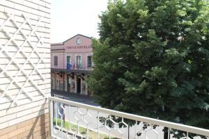 a building with a tree next to a fence at L'appartamento della Stazione di Saronno in Saronno