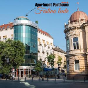 un edificio con una cúpula al lado de una calle en Apartment Penthouse Festina Lente, en Sombor