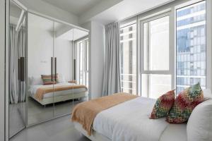 a bedroom with a bed and a large window at Exclusive Meier on Rothschild by Five Stay in Tel Aviv