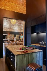 a kitchen with a large wooden island in the middle at Villa Kamionka in Kamionka +67 photos