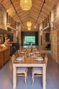 a dining room with a long table and chairs at Villa Kamionka in Kamionka