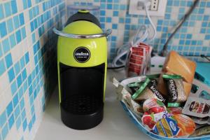 a green toaster on a counter next to a basket of food at Maison Leone Apartment in Ravenna