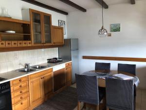 a kitchen with a table with chairs and a sink at Villa Conte in Korčula
