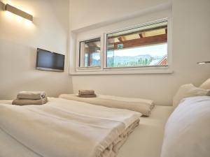 three beds in a room with a flat screen tv at Alpine Apartment Pia 6 - Bad Mitterndorf by AA Holiday Homes in Bad Mitterndorf