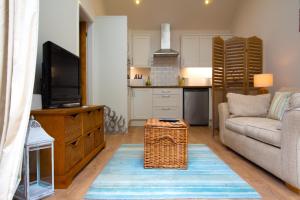 a living room with a couch and a tv at The Garden Suite Annex, Hoole by Rework Accommodation in Chester