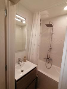 a bathroom with a sink and a shower and a tub at Borsalino Apartman in Veszprém