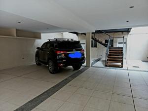 a black suv parked in a garage at Grace Apartaments in San Juan