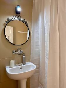 a bathroom with a sink and a mirror at Camere de inchiriat Sibel in Costinesti