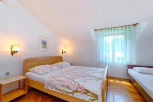 Postel nebo postele na pokoji v ubytování Apartments Marija