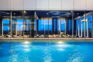 a swimming pool in front of a building at Best Western Premier The Hive in Jakarta