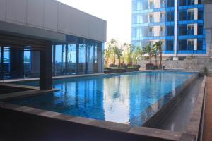 a large swimming pool in front of a building at Best Western Premier The Hive in Jakarta