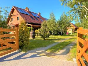 a wooden fence in front of a house at Liwia Park in Niechorze