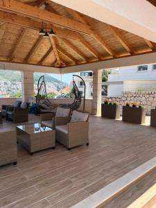 a patio with couches and chairs on a roof at Luxury Apartments in Dubrovnik