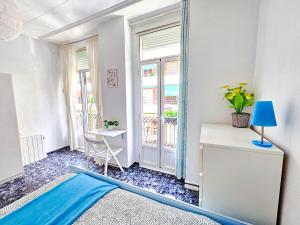 a room with a mirror and a table and a window at Your home in Valencia in Valencia