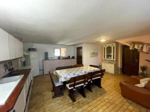 a kitchen with a table in the middle of a room at SemiInterrato Giardino,BBQ,Mare in Carbonia