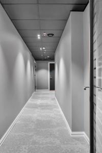 an empty corridor with white walls and a ceiling at Enter St. Elisabeth Suites in Tromsø