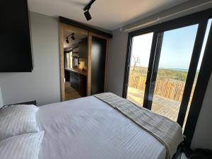 a bedroom with a bed and a view of the ocean at Likya Garden Life in Gâvurağılı