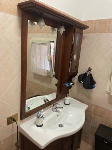 a bathroom with a sink and a mirror at Appartamento Roma Battistini in Rome